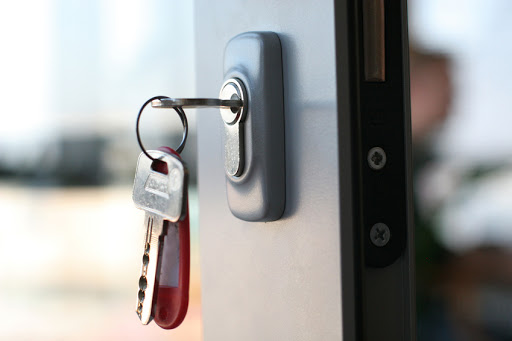 Person using a screwdriver to a door